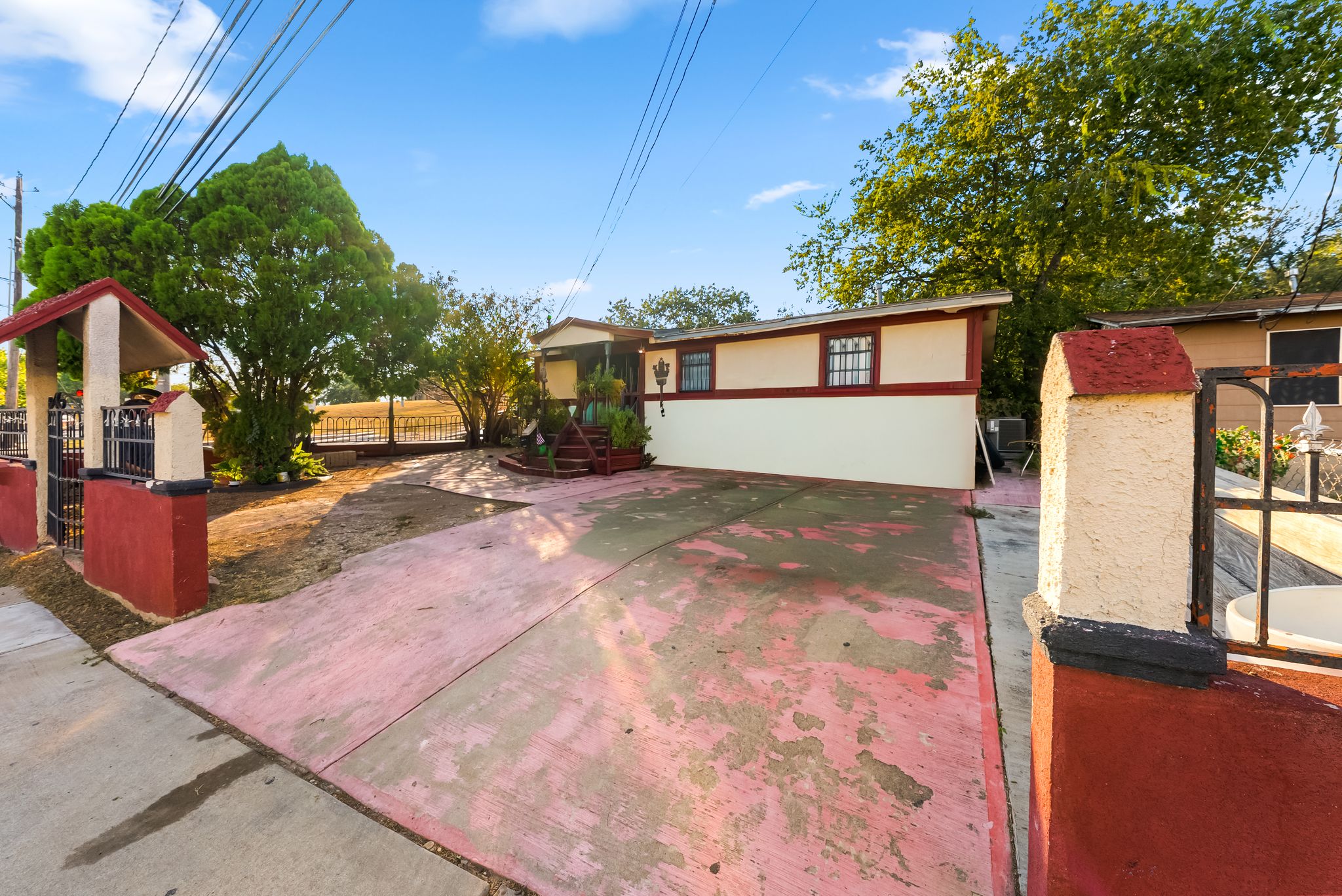 2900 Webberville Road Austin, TX 78702 - Photo 20 of 22 An expansive driveway leads directly toward the single-level home set under a clear sky.