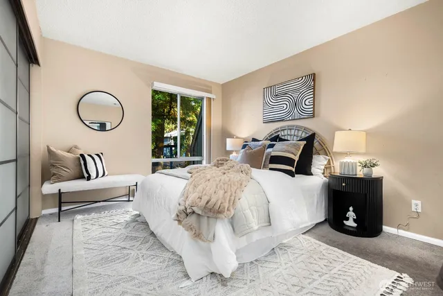 a spacious bedroom with a bed and a large window