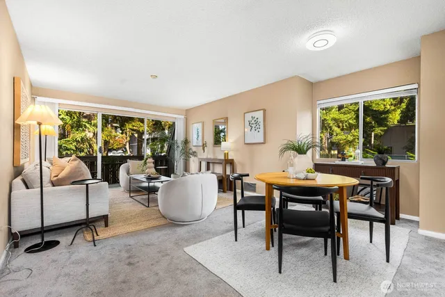 a living room with furniture a large window and a table