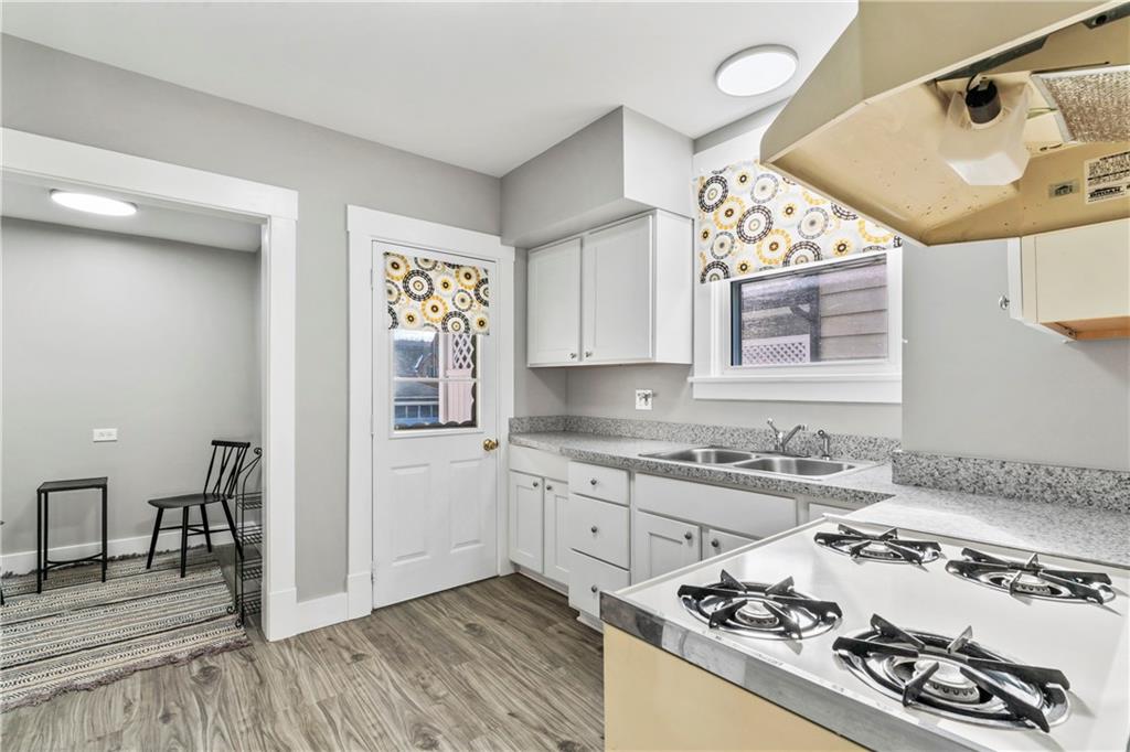 745 Bank Street Beaver, PA 15009 - Photo 13 of 30 a kitchen with a stove a sink and a refrigerator