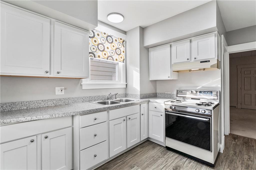 745 Bank Street Beaver, PA 15009 - Photo 14 of 30 a kitchen with granite countertop white cabinets and white stainless steel appliances