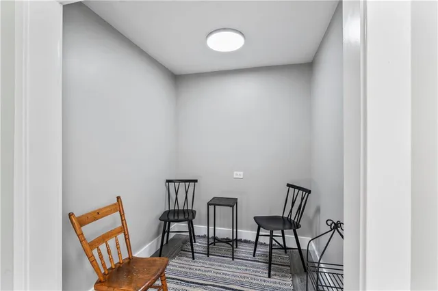 an empty room with a window and a ceiling fan