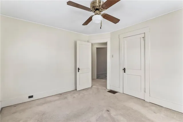 an empty room with a ceiling fan