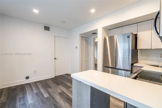 a room with a sink and a refrigerator