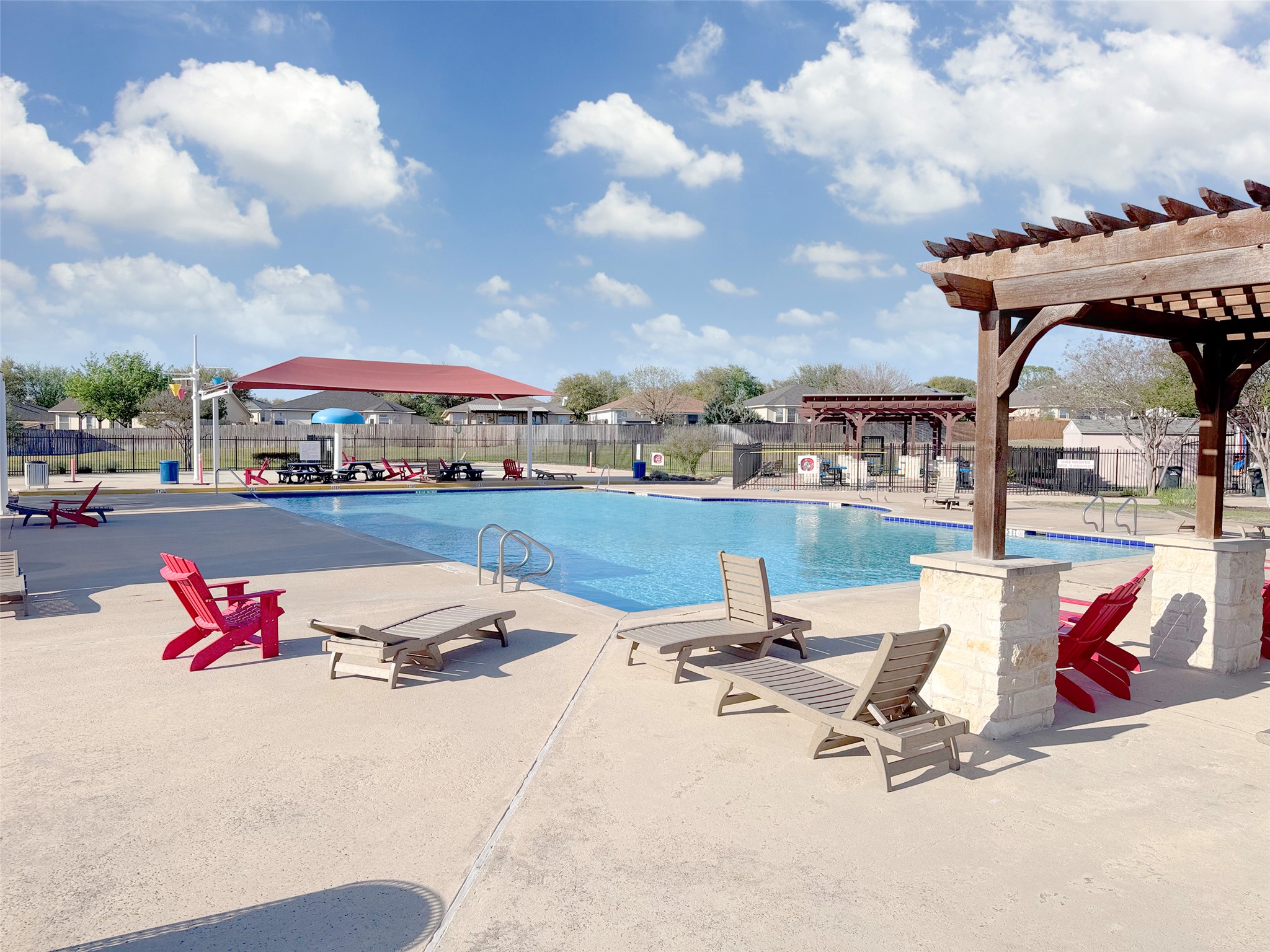 251 Triumph Road Buda, TX 78610 - Photo 23 of 24 Community pool with a pergola and a patio