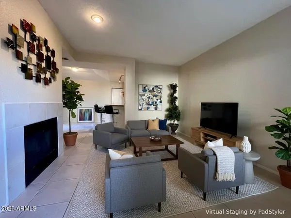 a living room with furniture wooden floor and a fireplace