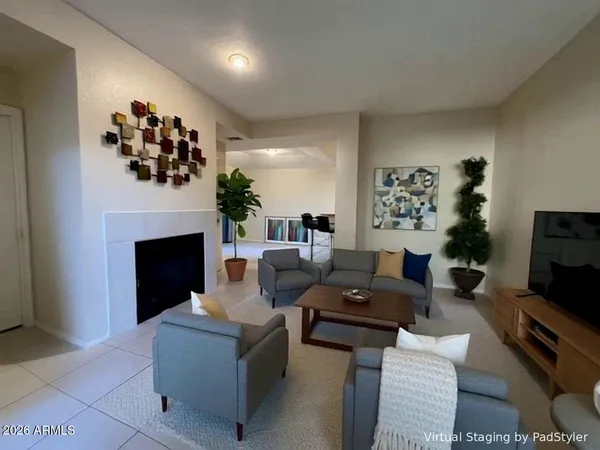 a living room with furniture a fireplace and a flat screen tv