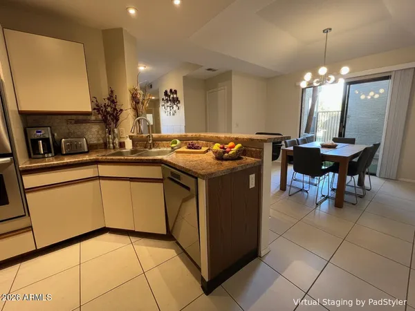 a kitchen with stainless steel appliances kitchen island granite countertop a sink a stove a counter top space and cabinets