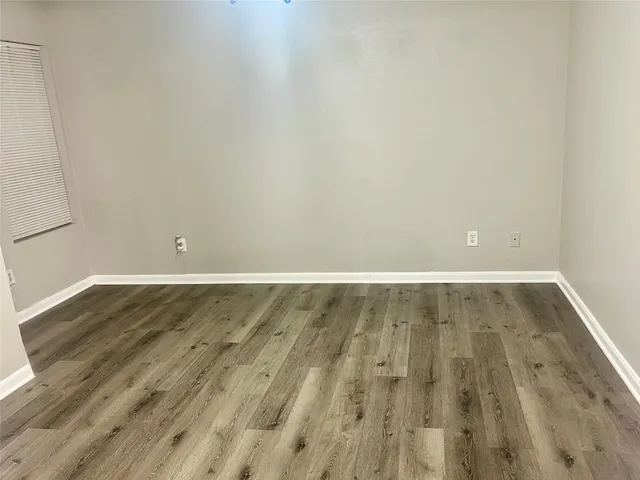 a view of room with wooden floor