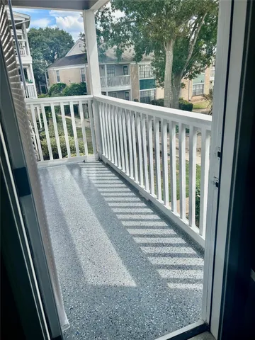 a view of balcony with wooden floor