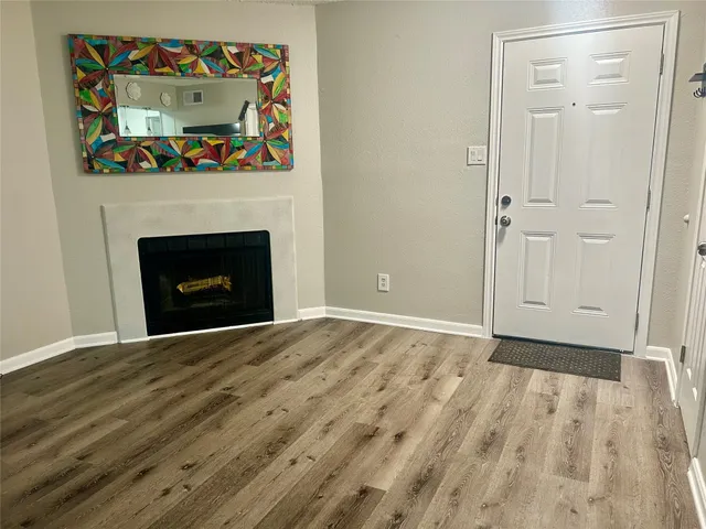 a view of empty room with a fireplace