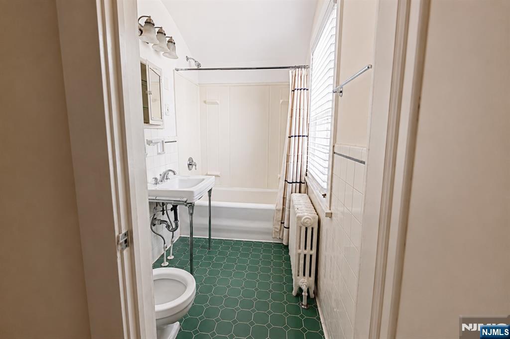 298 Audubon Road Englewood, NJ 07631 - Photo 11 of 19 a bathroom with a shower a toilet and a sink