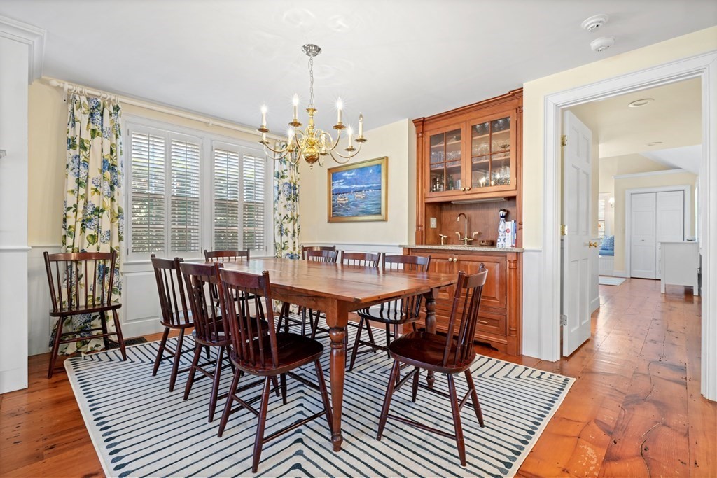 39 Milk Street Nantucket, MA 02554 - Photo 11 of 22 a view of a dining room with furniture wooden floor and chandelier
