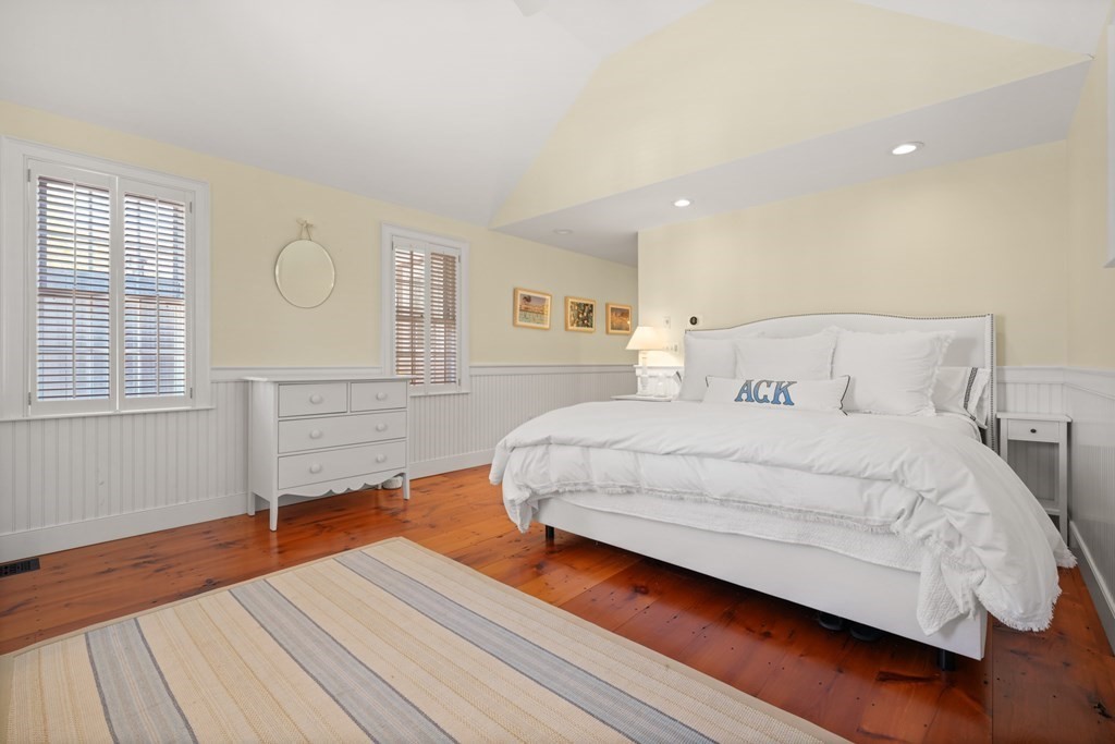 39 Milk Street Nantucket, MA 02554 - Photo 14 of 22 a bedroom with a bed and wooden floor