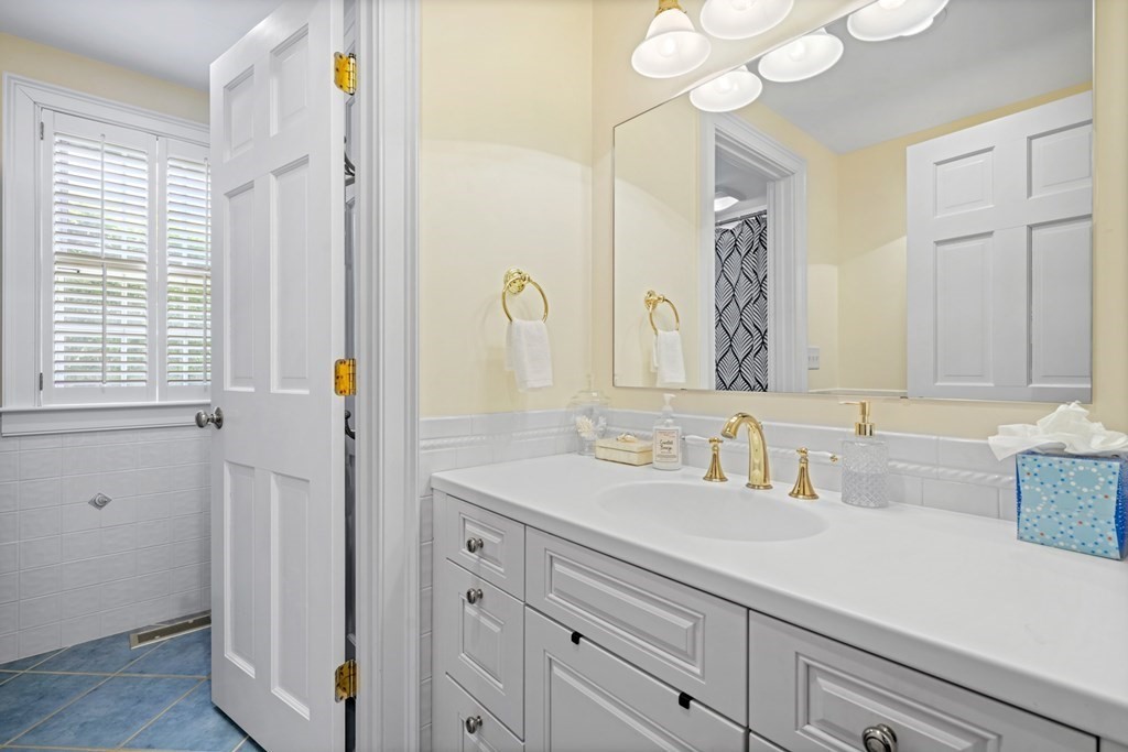 39 Milk Street Nantucket, MA 02554 - Photo 17 of 22 a bathroom with a sink a vanity and a mirror
