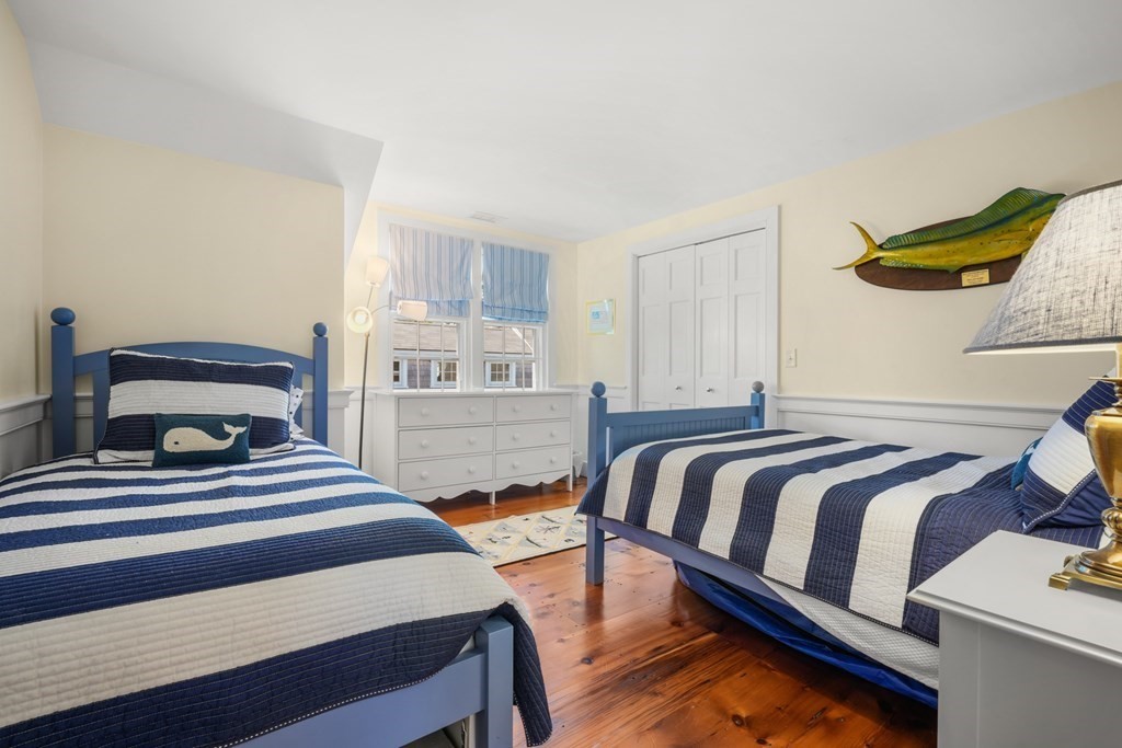 39 Milk Street Nantucket, MA 02554 - Photo 19 of 22 a bedroom with a bed and window