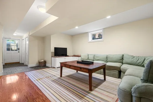 a living room with furniture and a wooden floor