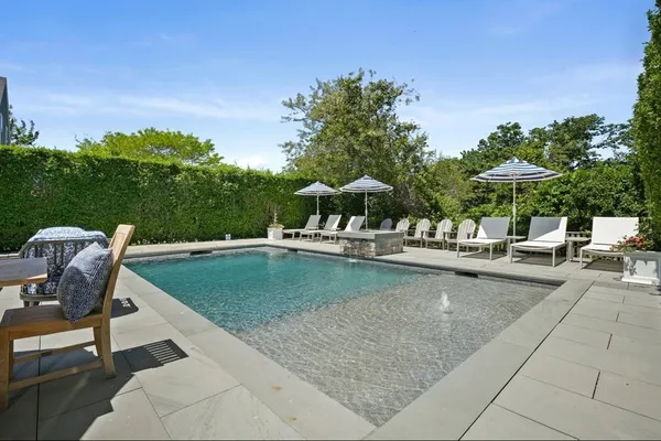 a view of a swimming pool with chairs