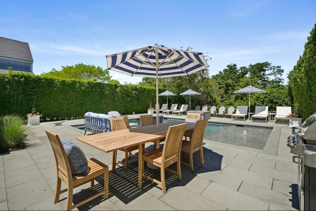 39 Milk Street Nantucket, MA 02554 - Photo 4 of 22 a view of a patio with a table and chairs