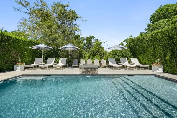 a view of a patio with table and chairs under an umbrella