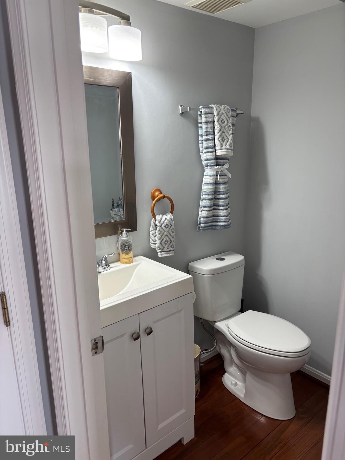 3910 Squire Tuck Way Baltimore, MD 21208 - Photo 12 of 40 a bathroom with a sink a toilet and mirror