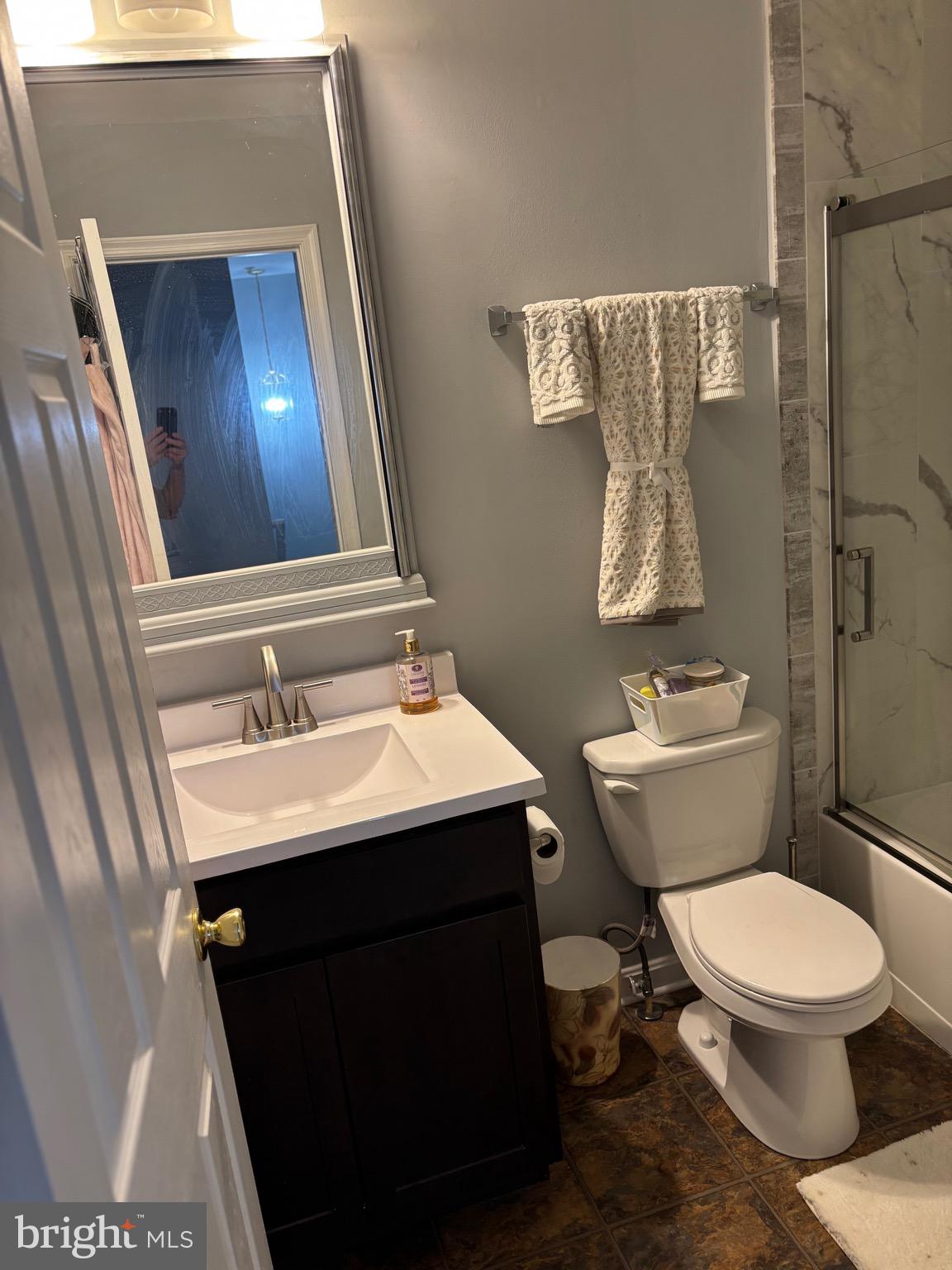3910 Squire Tuck Way Baltimore, MD 21208 - Photo 18 of 40 a bathroom with a sink toilet and shower