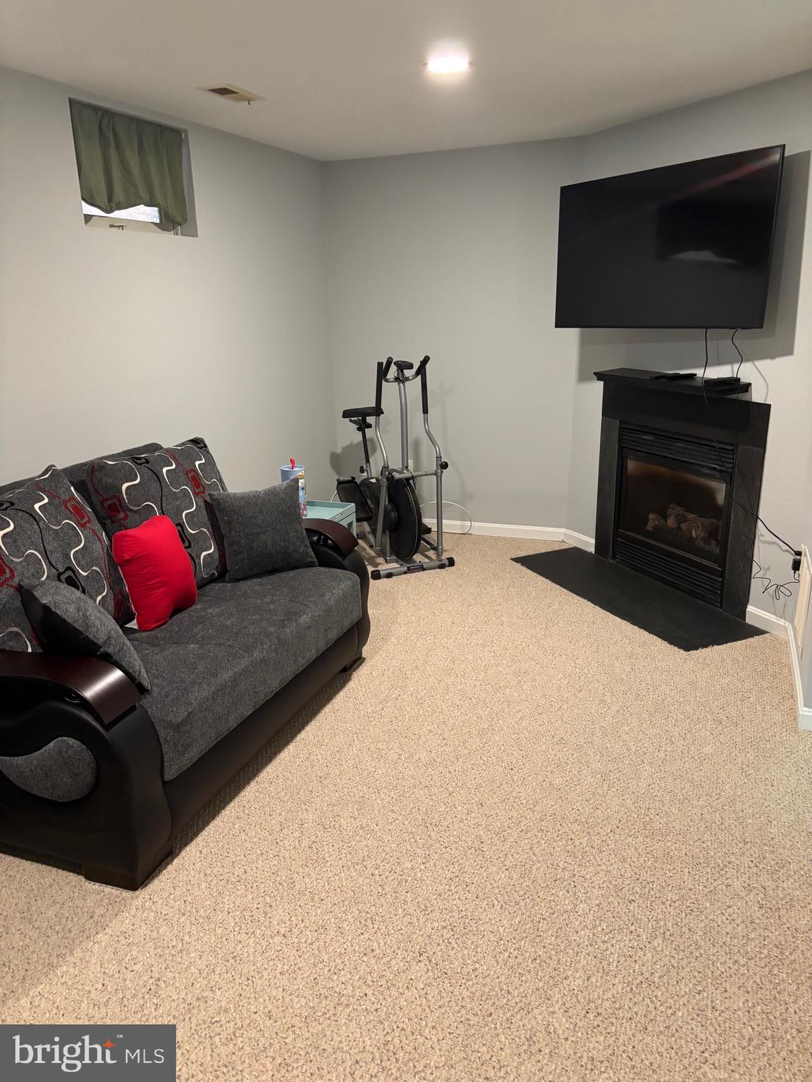 3910 Squire Tuck Way Baltimore, MD 21208 - Photo 24 of 40 a living room with furniture a flat screen tv and a fireplace