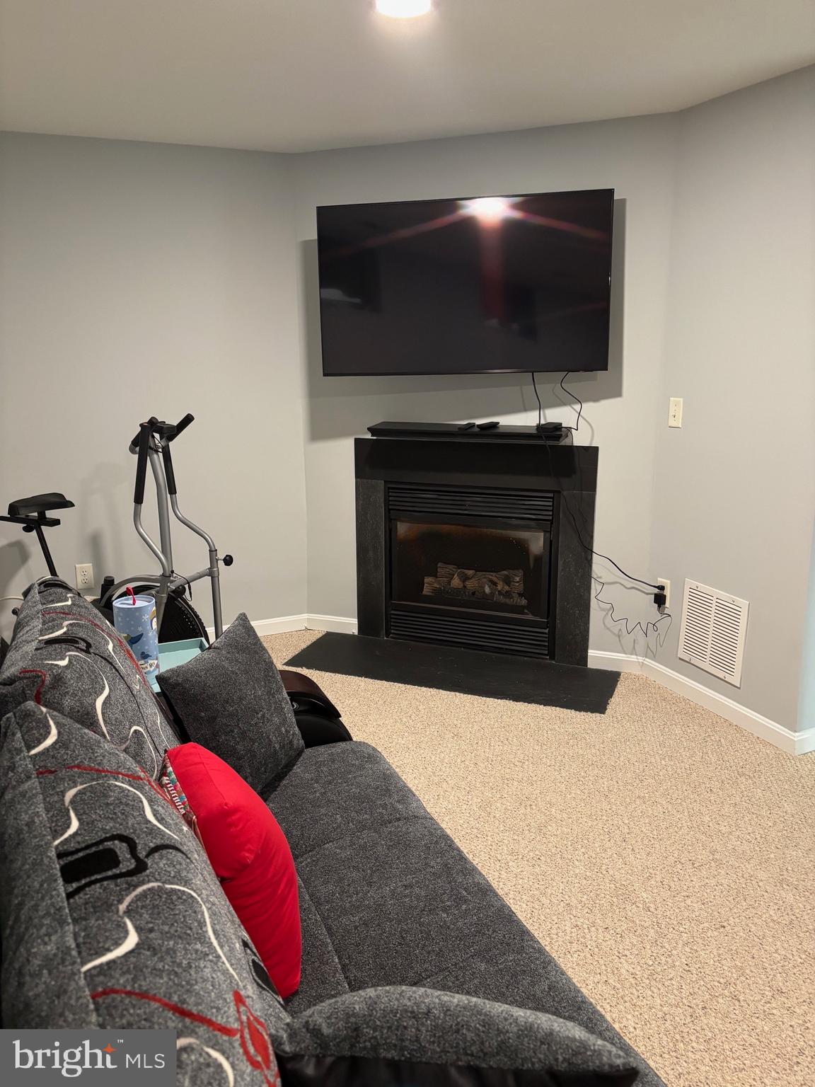 3910 Squire Tuck Way Baltimore, MD 21208 - Photo 25 of 40 a living room with furniture a flat screen tv and a fireplace
