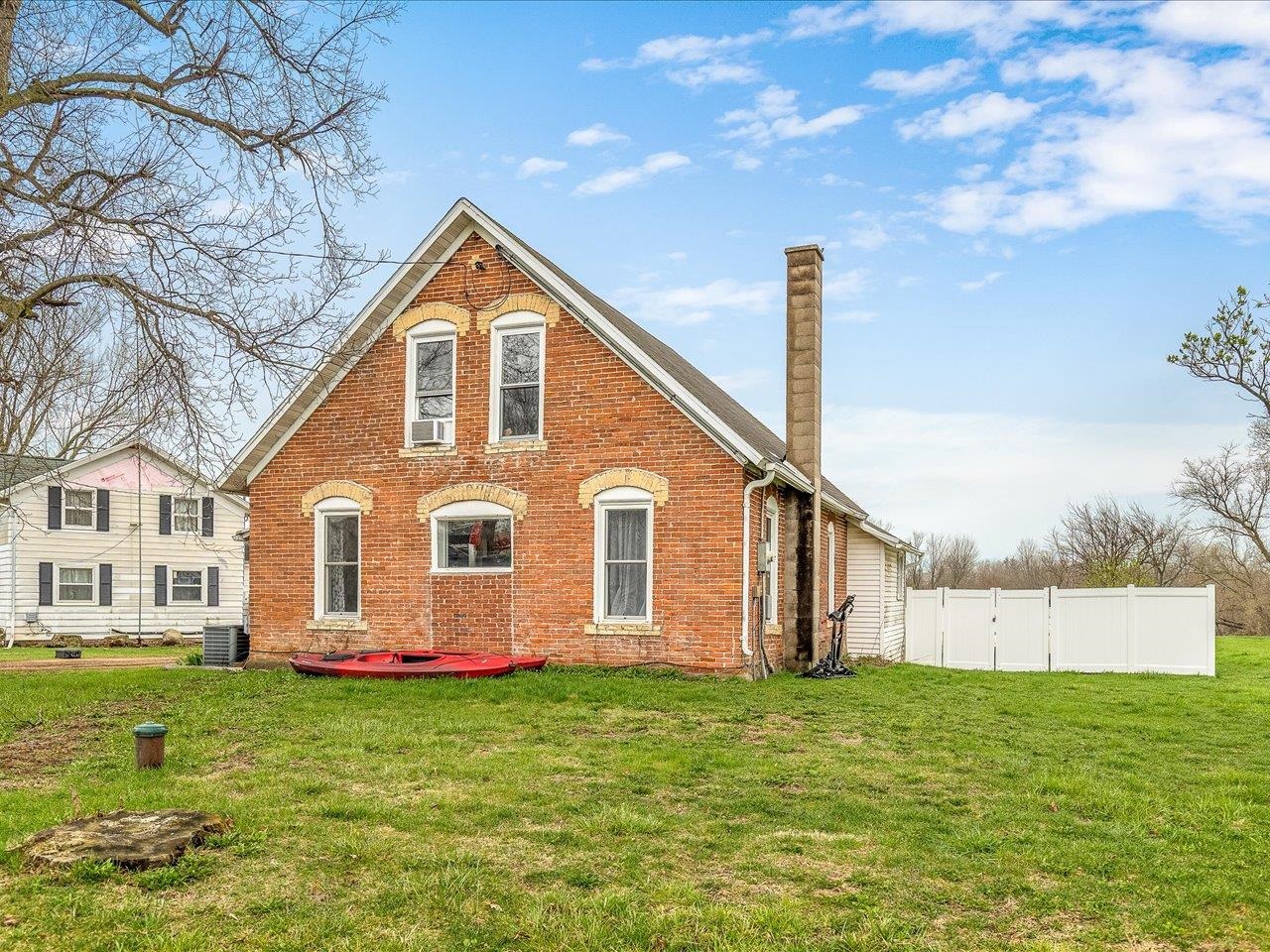 a front view of a house with a yard and trees