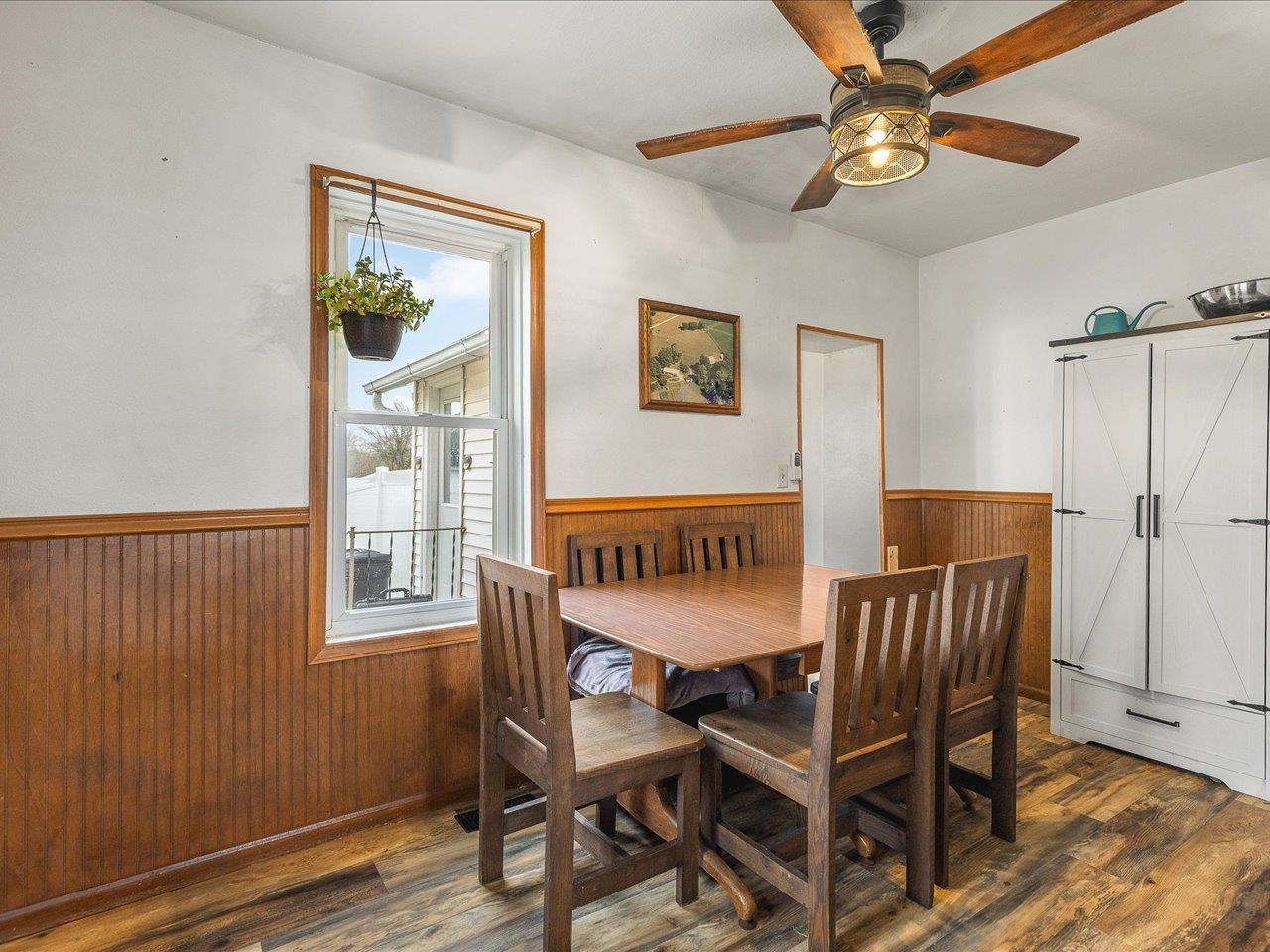 13514 Northeast Winslow Road Winslow, IL 61089 - Photo 12 of 31 a dining room with furniture a chandelier and wooden floor