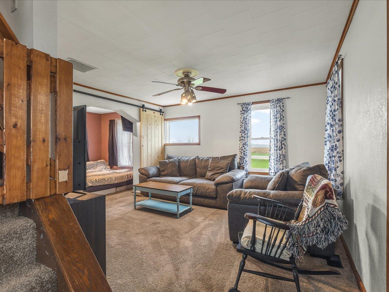 13514 Northeast Winslow Road Winslow, IL 61089 - Photo 14 of 31 a living room with furniture a ceiling fan and a window