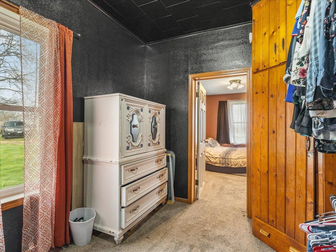 13514 Northeast Winslow Road Winslow, IL 61089 - Photo 21 of 31 a view of walk in closet with clothes and shoes