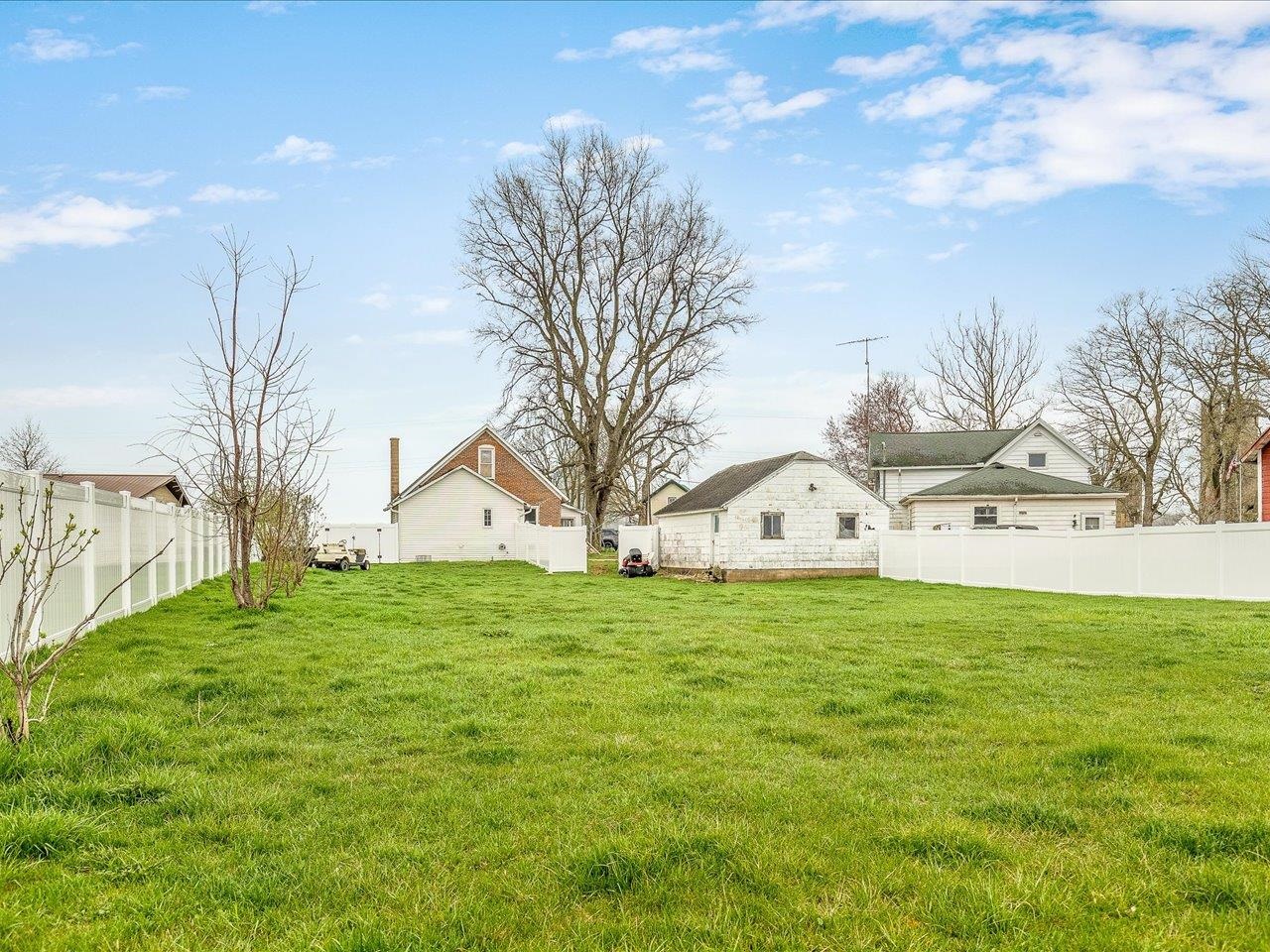 13514 Northeast Winslow Road Winslow, IL 61089 - Photo 31 of 31 a large white house with a big yard and large trees