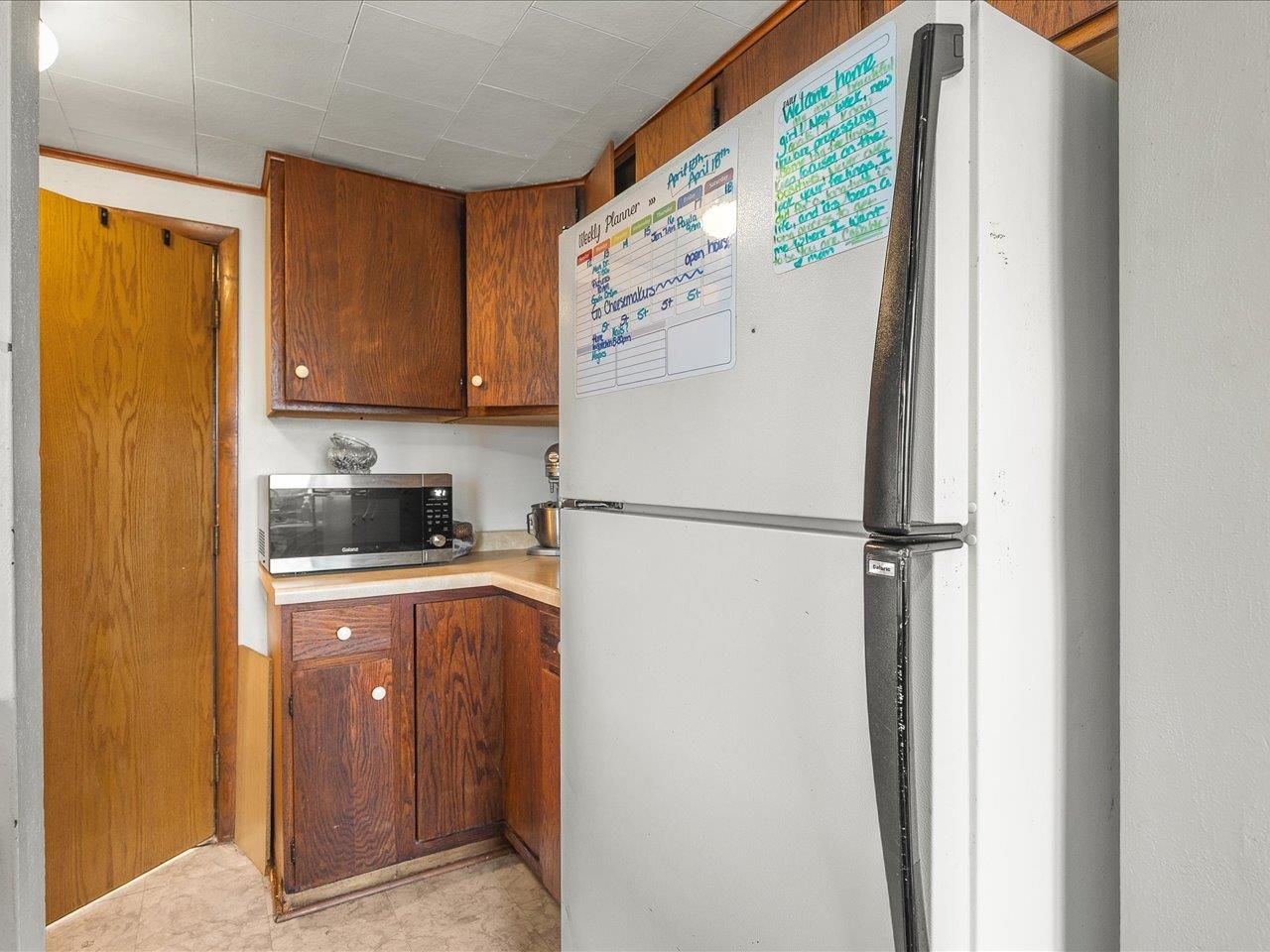 13514 Northeast Winslow Road Winslow, IL 61089 - Photo 5 of 31 a white refrigerator freezer sitting in a kitchen