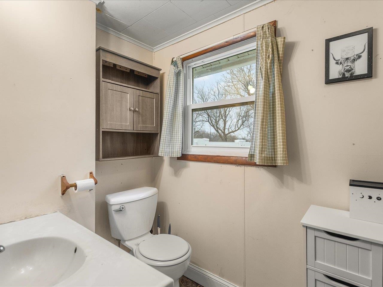 13514 Northeast Winslow Road Winslow, IL 61089 - Photo 8 of 31 a bathroom with a toilet sink and mirror