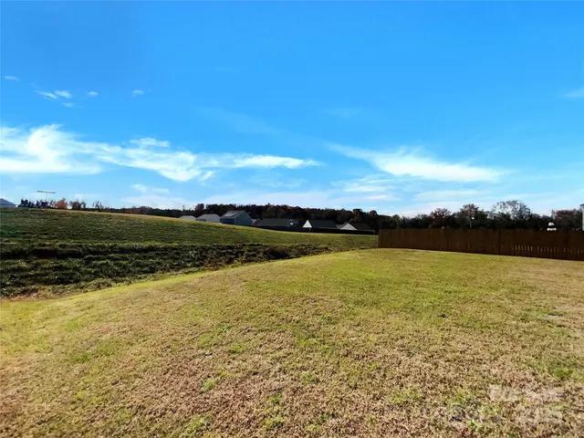 a kitchen with stainless steel appliances granite countertop a sink refrigerator and cabinets