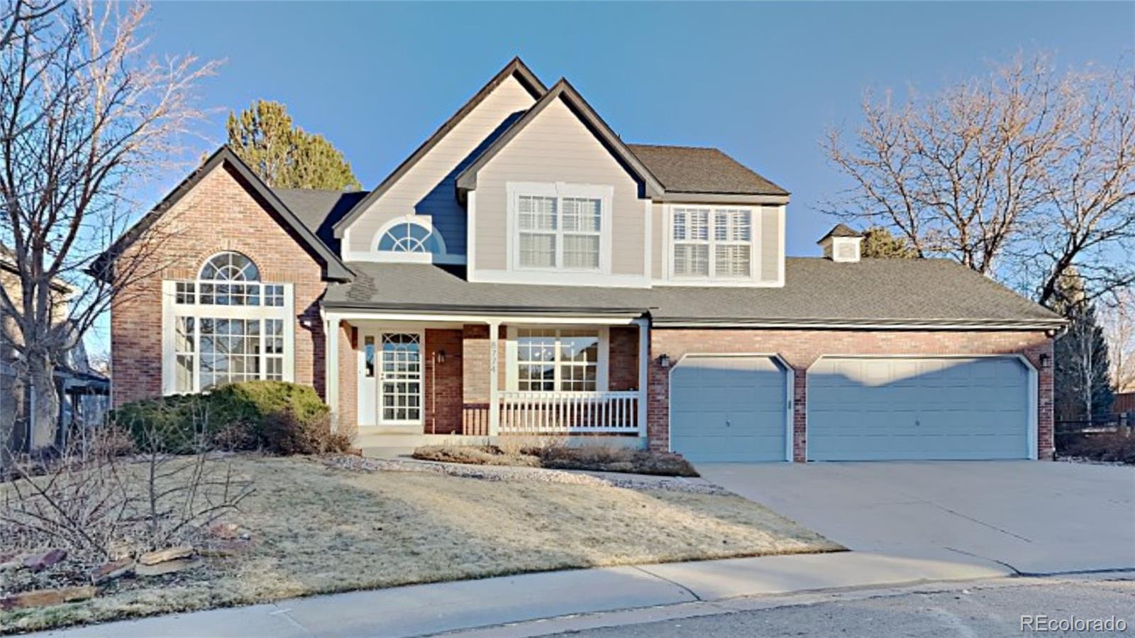 8774 Forrest Court Highlands Ranch, CO 80126 - Photo 1 of 31 a front view of a house with garden