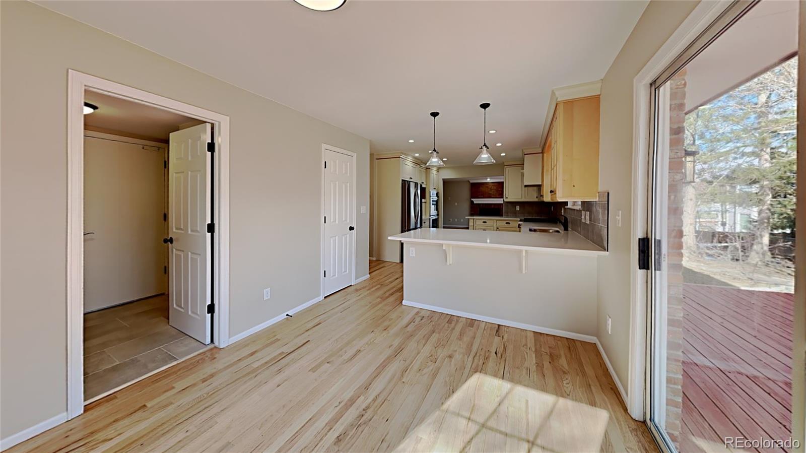 8774 Forrest Court Highlands Ranch, CO 80126 - Photo 12 of 31 a view of a kitchen with a sink and dishwasher with wooden floor