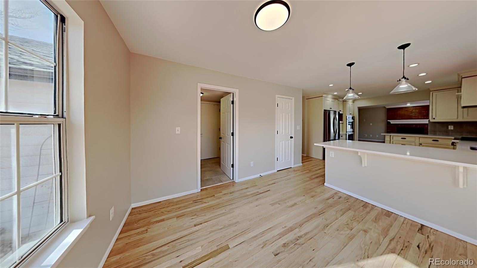 8774 Forrest Court Highlands Ranch, CO 80126 - Photo 13 of 31 a view of kitchen and hall with wooden floor