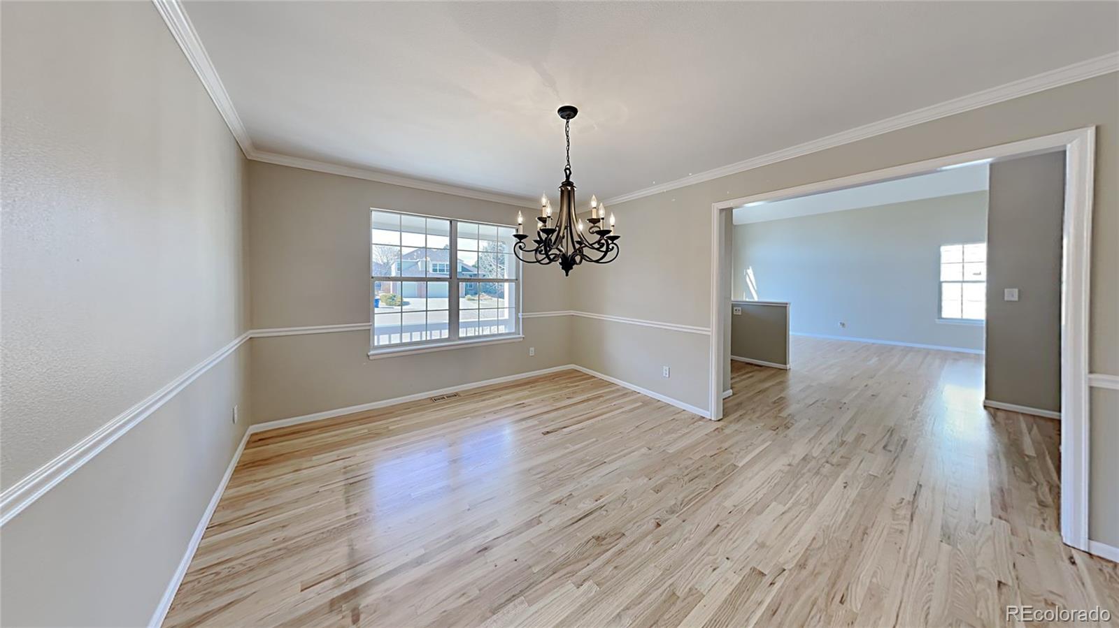 8774 Forrest Court Highlands Ranch, CO 80126 - Photo 2 of 31 a view of empty room with wooden floor and fan
