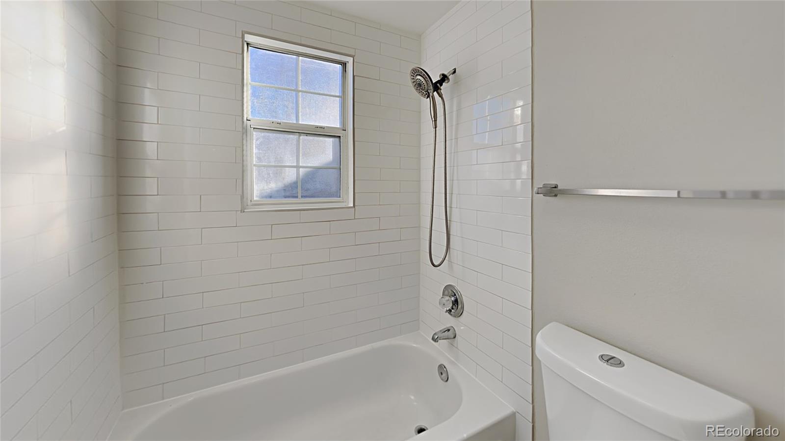 8774 Forrest Court Highlands Ranch, CO 80126 - Photo 23 of 31 a bathroom with a bathtub and window