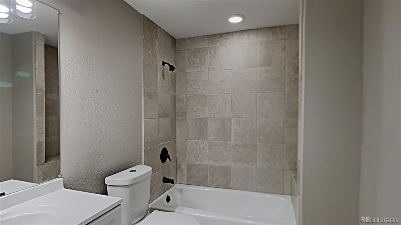 8774 Forrest Court Highlands Ranch, CO 80126 - Photo 24 of 31 a bathroom with a bathtub and a toilet