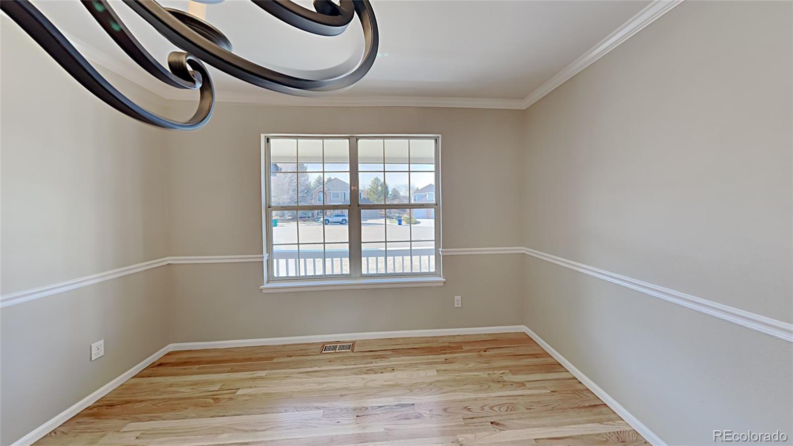 8774 Forrest Court Highlands Ranch, CO 80126 - Photo 3 of 31 a view of a room with wooden floor and windows