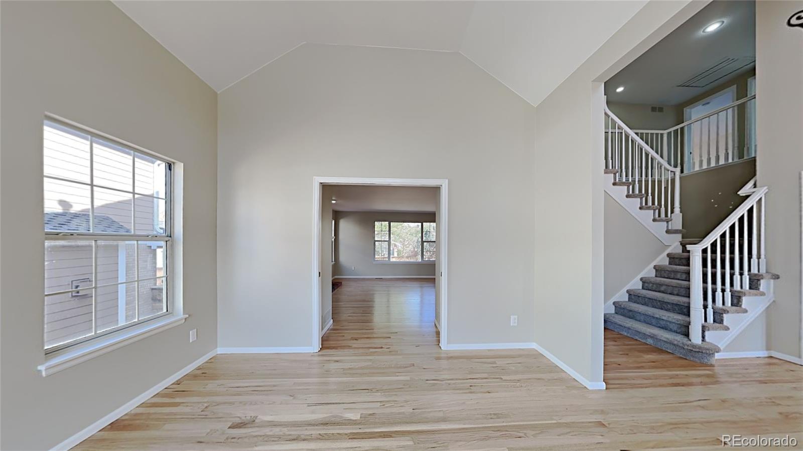 8774 Forrest Court Highlands Ranch, CO 80126 - Photo 7 of 31 a view of entryway and hall with wooden floor