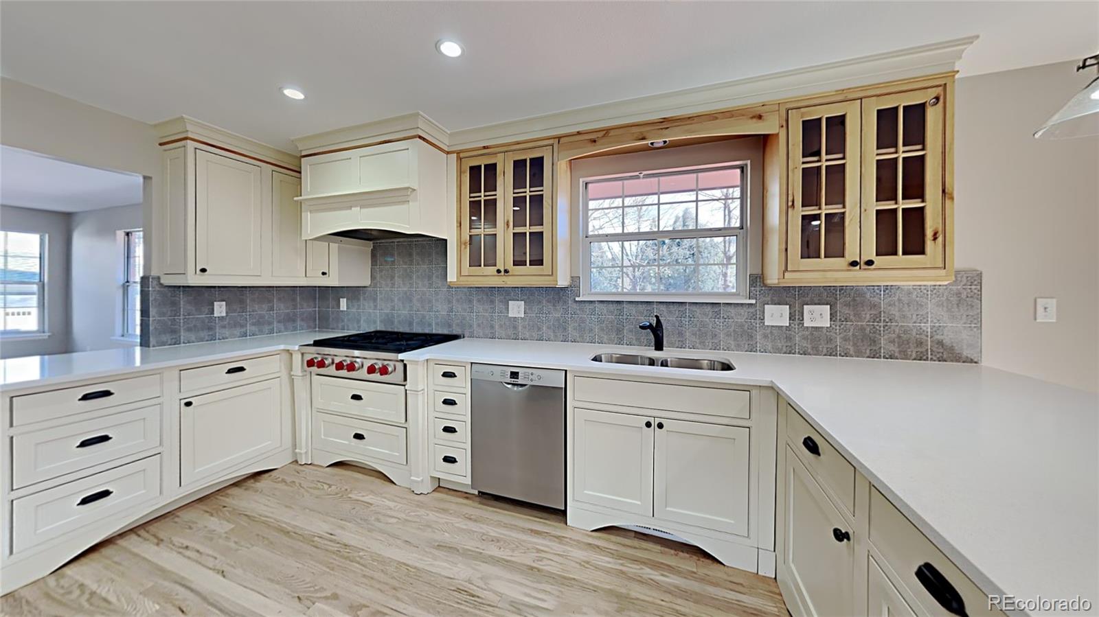 8774 Forrest Court Highlands Ranch, CO 80126 - Photo 10 of 31 a kitchen with cabinets appliances and a window