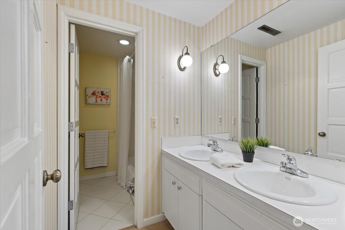 2606 49th Place Southwest Everett, WA 98203 - Photo 24 of 37 a bathroom with a double vanity sink and a mirror