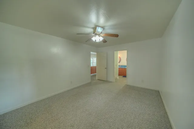a large kitchen with kitchen island a sink a stove and a wooden floors
