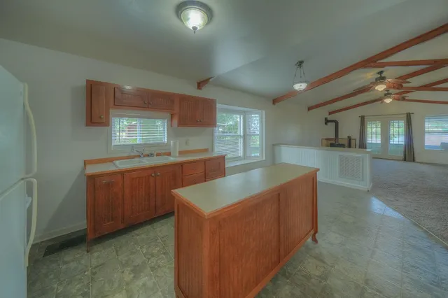 a kitchen with cabinets and window