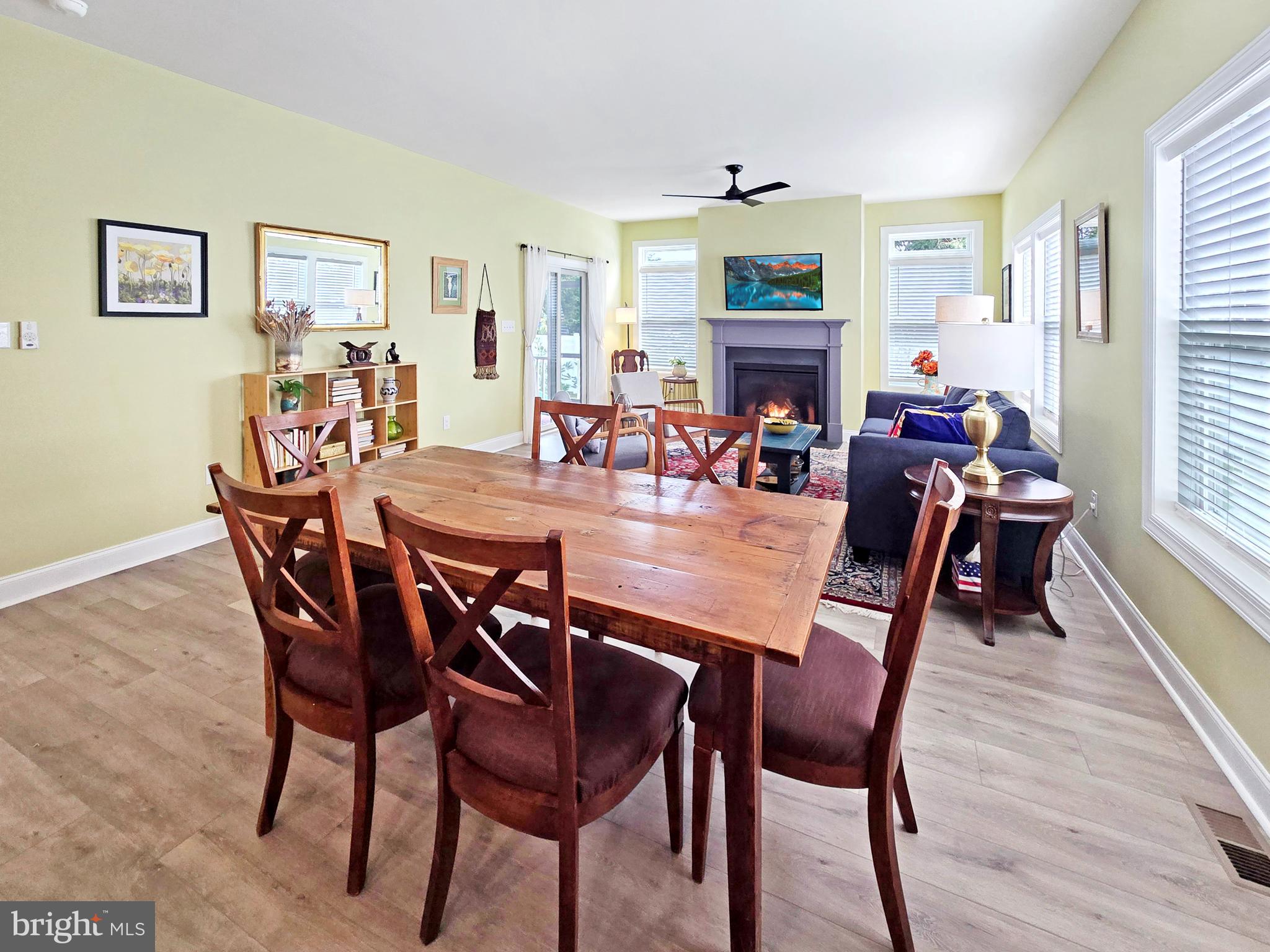 33768 Catching Cove Lewes, DE 19958 - Photo 17 of 69 a dining room with furniture wooden floor a painting and a chandelier
