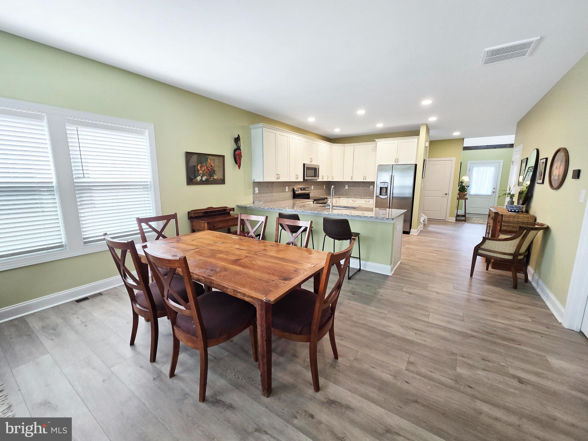 33768 Catching Cove Lewes, DE 19958 - Photo 18 of 69 a view of a dining room with furniture and wooden floor